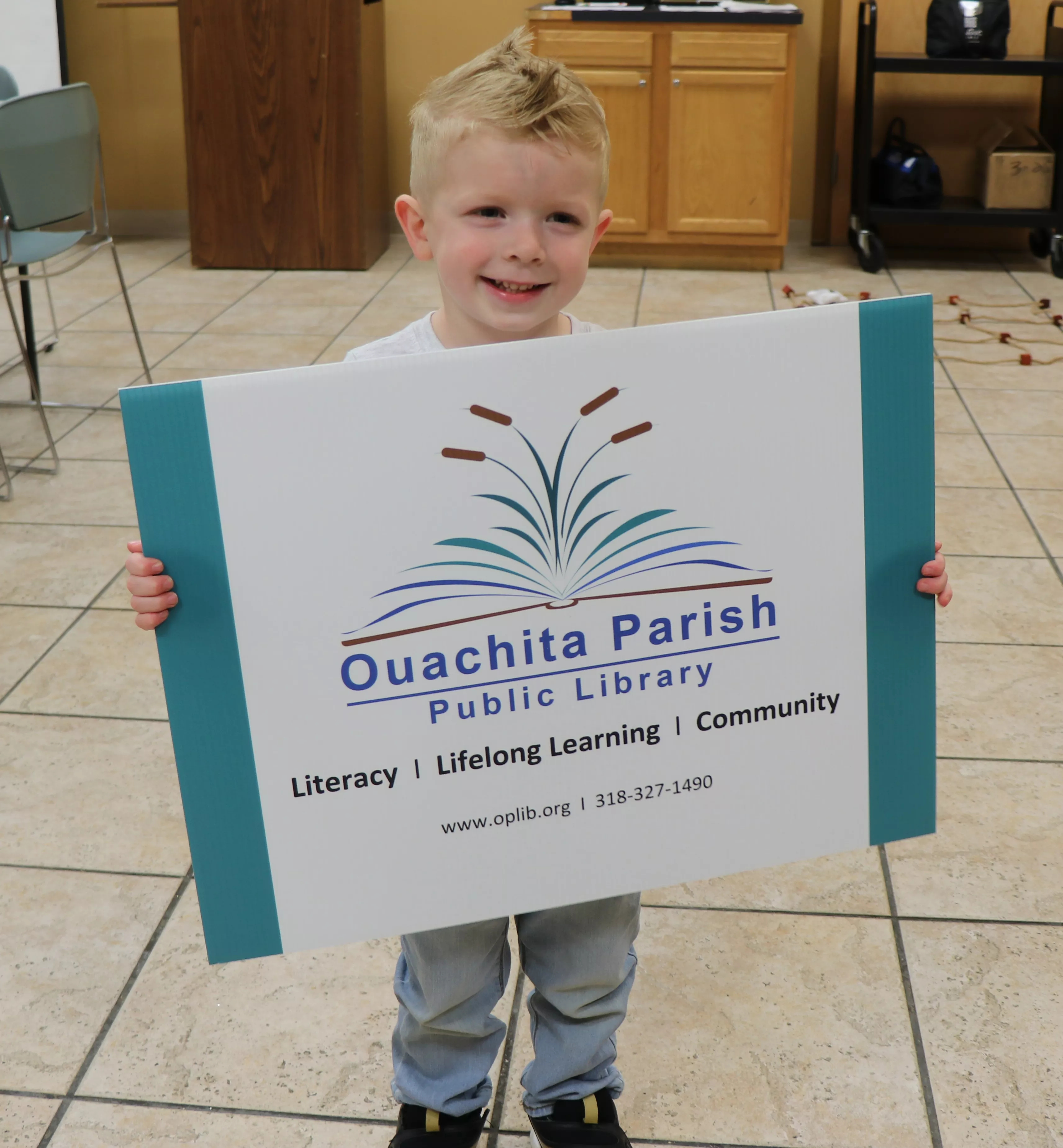 Boy holding giant library card