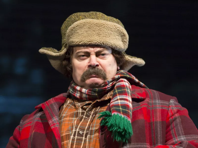 Nick Offerman portrays Ignatius J. Reilly, a mustachioed man-child in a green hunting cap and several layers of plaid flannel